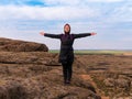 Traveler hiker woman with backpack raised hands on mountain summit Girl backpacker enjoying scenic landscape aerial view Royalty Free Stock Photo