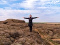 Traveler hiker woman with backpack raised hands on mountain summit Girl backpacker enjoying scenic landscape aerial view Royalty Free Stock Photo