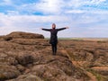 Traveler hiker woman with backpack raised hands on mountain summit Girl backpacker enjoying scenic landscape aerial view Royalty Free Stock Photo