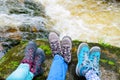 Traveler hiking boots near river on nature background