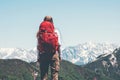 Traveler hiking in mountains with red backpack
