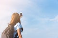 Traveler hiking photographer woman has take a photo of the blue