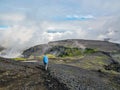 Traveler hiking women walking on road in Iceland highlands with heavy backpack Travel Lifestyle freedom concept adventure active Royalty Free Stock Photo