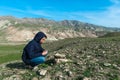 Traveler holding a compass in mountains Royalty Free Stock Photo