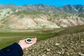 Traveler holding a compass in mountains Royalty Free Stock Photo