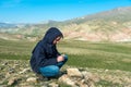 Traveler holding a compass in mountains Royalty Free Stock Photo