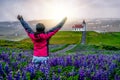 Traveler in Iceland. Church and Lupine Flowers