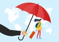 Traveler insurance concept. Agent hand holding umbrella above traveling woman with baggage suitcase in protect face mask Royalty Free Stock Photo