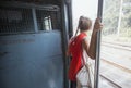 Traveler leans out train in India
