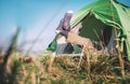 Traveler legs in socks stick out from camping tent