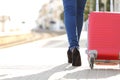 Traveler legs walking with luggage in a train station