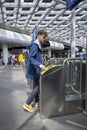 A traveler listening music and rushing to the platform