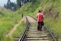 A traveler and a local meeting on the rail going to or from Ella