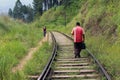 A traveler and a local meeting on the rail going to or from Ella