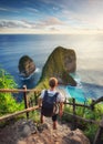 Traveler look at the ocean and rocks. Travel and active life concept. Adventure and travel on Bali, Indonesia.