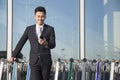 Traveler looking at cellphone next to row of luggage carts Royalty Free Stock Photo