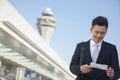 Traveler looking at ticket at airport Royalty Free Stock Photo