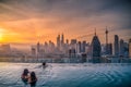 Traveler looking view skyline Kuala Lumpur city in swimming pool on the roof top of hotel at sunrise in Kuala Lumpur, Malaysia