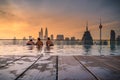 Traveler looking view skyline Kuala Lumpur city in swimming pool on the roof top of hotel at sunrise in Kuala Lumpur, Malaysia