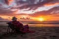 traveler, lounging on beach, with view of exotic sunset Royalty Free Stock Photo