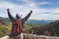 Traveler Man with backpack hands raised mountains landscape on background Royalty Free Stock Photo