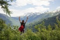 Traveler Man with backpack raised hands. mountains landscape on background Royalty Free Stock Photo