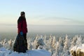 A traveler on top of a winter mountain admires the scenery Royalty Free Stock Photo