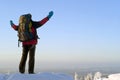 A traveler on top of a winter mountain admires the scenery Royalty Free Stock Photo