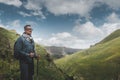 Traveler Man With Backpack And Trekking Poles Resting And Looking At The Mountains In Summer Outdoor Royalty Free Stock Photo