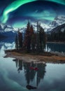 Traveler man canoeing on Spirit Island with aurora borealis over rocky mountains in the night at Jasper national park Royalty Free Stock Photo