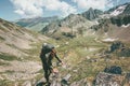 Traveler man climbing in mountains with backpack Travel Lifestyle hiking Royalty Free Stock Photo