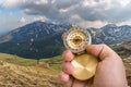 Traveler man with compass seeking a right way in the mountains Royalty Free Stock Photo