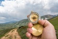 Traveler man with compass seeking a right way in the mountains Royalty Free Stock Photo