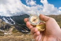 Traveler man with compass seeking a right way in the mountains Royalty Free Stock Photo