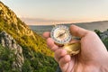 Traveler man with compass seeking a right way in the mountains Royalty Free Stock Photo