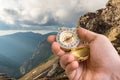 Traveler man with compass seeking a right way in the mountains Royalty Free Stock Photo