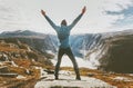 Traveler man exploring mountains alone happy raised hands