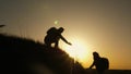 Traveler man extends his hand to a girl climbing to the top of a hill. travelers climb the cliff holding hand. teamwork Royalty Free Stock Photo