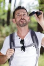 Traveler man looks through binoculars Royalty Free Stock Photo