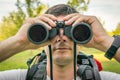 Traveler man looks through a binoculars Royalty Free Stock Photo