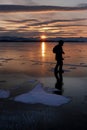 Traveler man and photographer walking across ice field of frozen Royalty Free Stock Photo