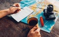 Traveler Man Planning Trip With Map, Top View. He Drinks Coffee