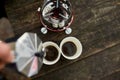 Traveler man pouring fresh hot coffee from geyser coffee maker into cup outdoor Royalty Free Stock Photo