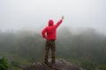 Traveler Man raised hands standing on cliff mountains adventure travel lifestyle concept summer vacations Royalty Free Stock Photo