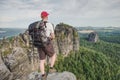 Traveler man on rocky edge with sharp rocks on background Royalty Free Stock Photo