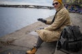 Handsome Traveling Man in winter coat And Hat In winter City, Urban Space.