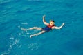 Traveler man swimmer with mask and snorkel is engaged in snorkeling in red sea, turquoise clear water Royalty Free Stock Photo