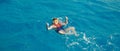 Traveler man swimmer with mask and snorkel is engaged in snorkeling in red sea, turquoise clear water banner Royalty Free Stock Photo