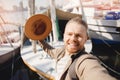 Traveler man takes selfie photo on background of sailing yacht. Concept trip or rent boat in port