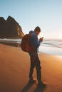 Traveler man with using smartphone on Kvalvika beach navigation technology